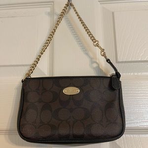 Small coach clutch. Has a small scuff mark on the front bottom left.